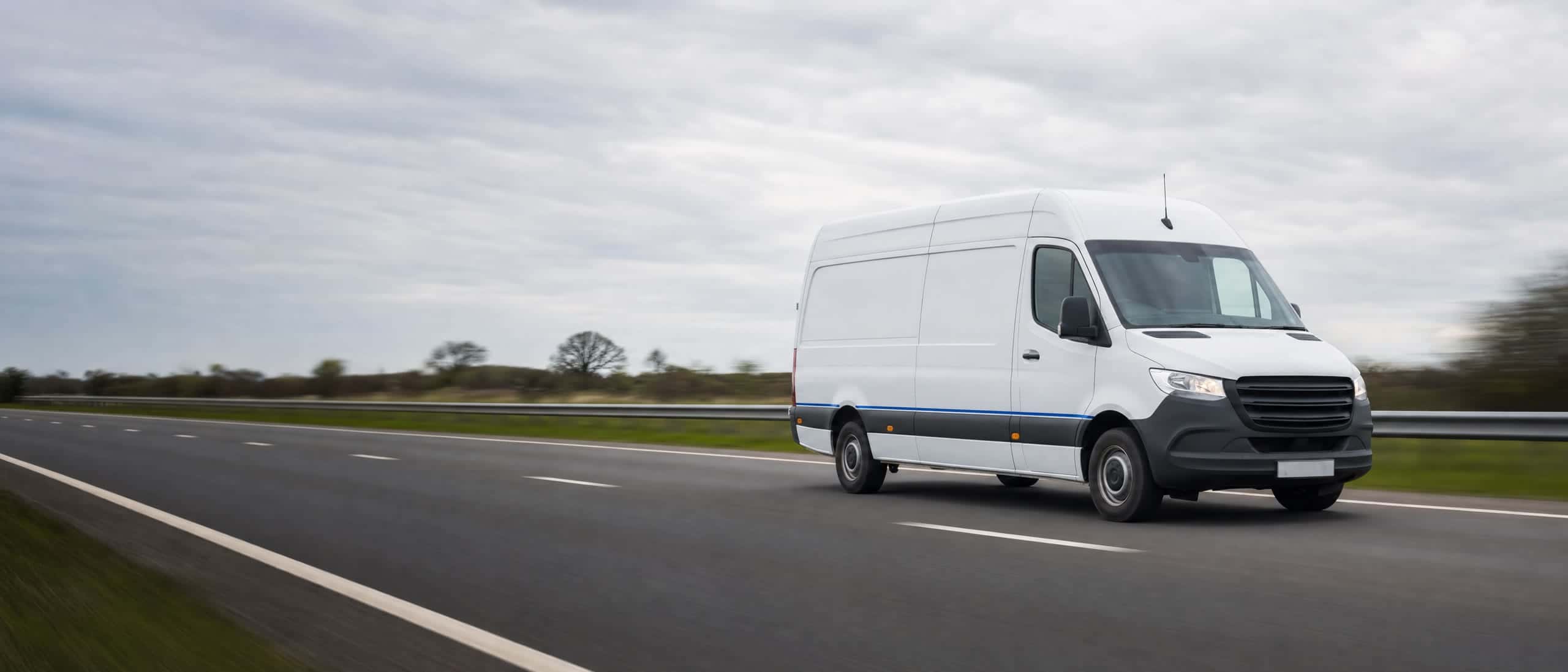 White Sky Routes long-wheelbase van travelling along a UK dual carriageway